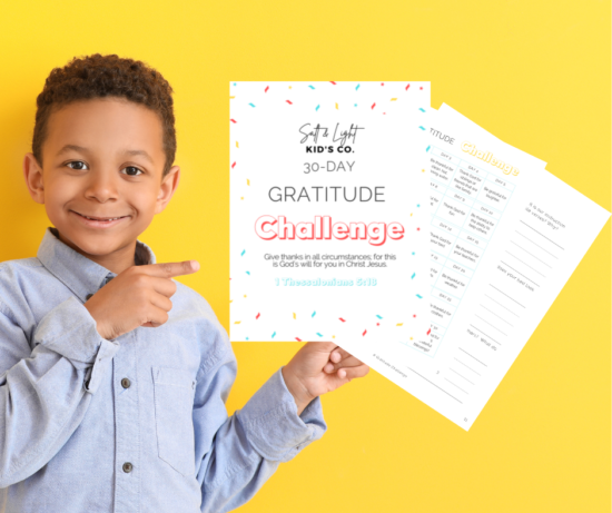 A boy holding up a sign with the words " gratitude challenge ".